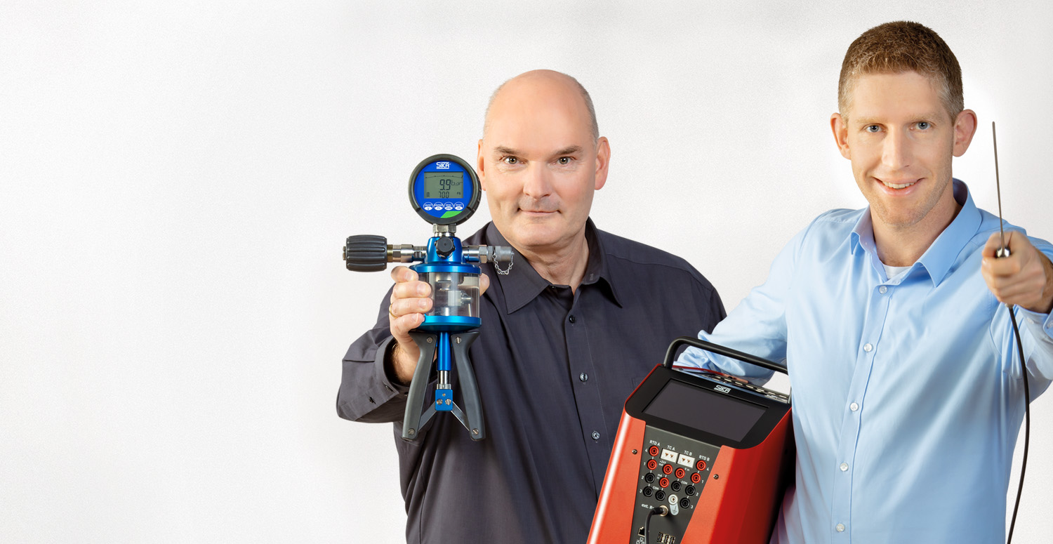 Two men holding calibration solution equipment, looking at the camera