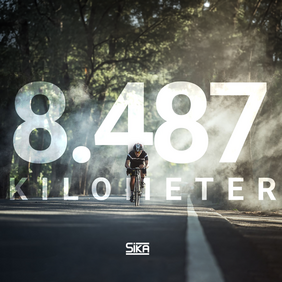 News; man on bicycle riding down street with the graphic 8.487 kilometer in background